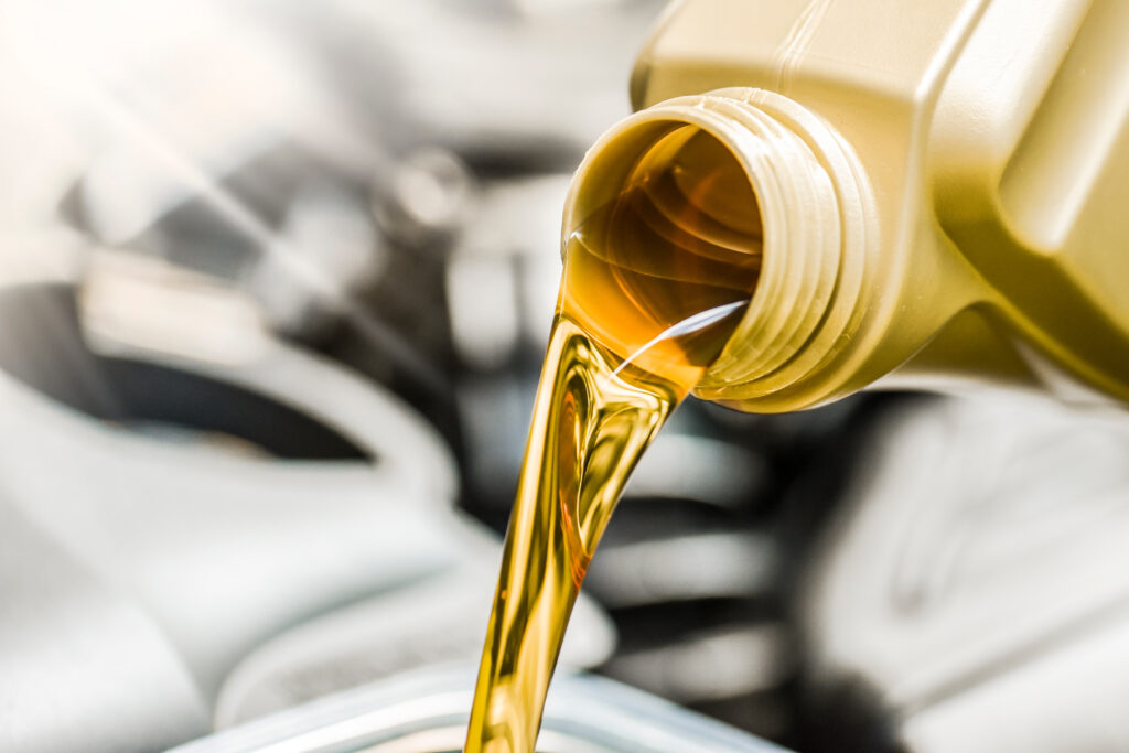 Synthetic motor oil being poured into an engine.