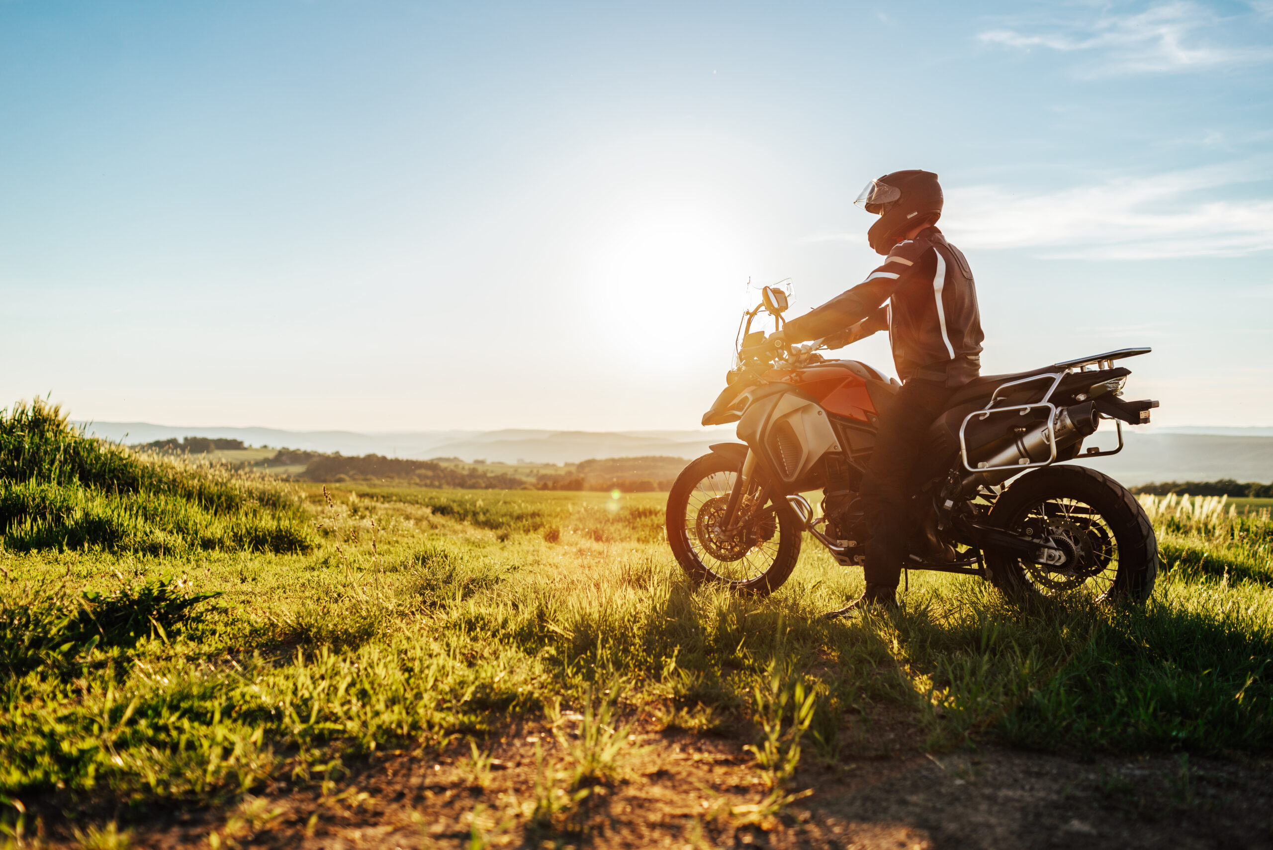 A motorcyclist looking out at a beautiful landscape.