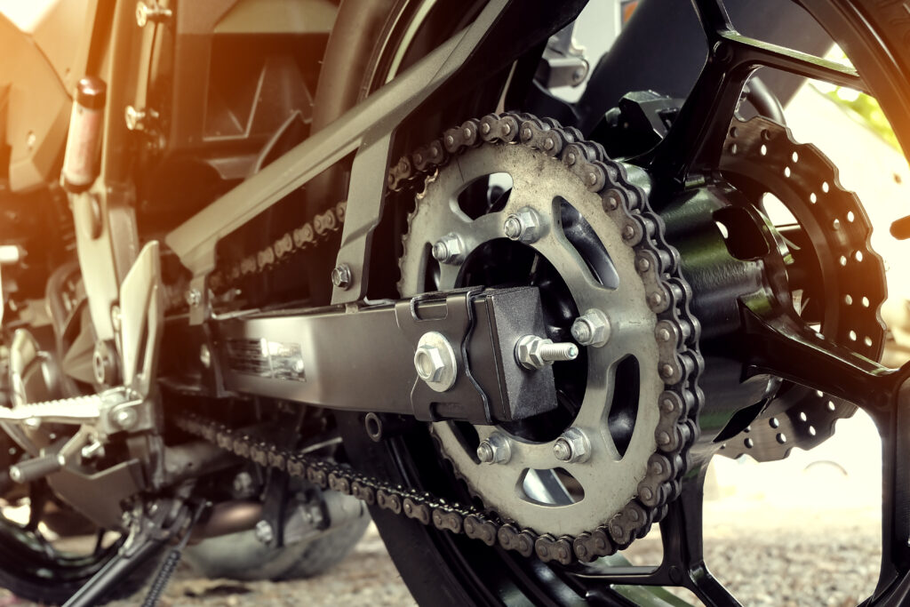 An up close look at a motorcycle's chain assembly.