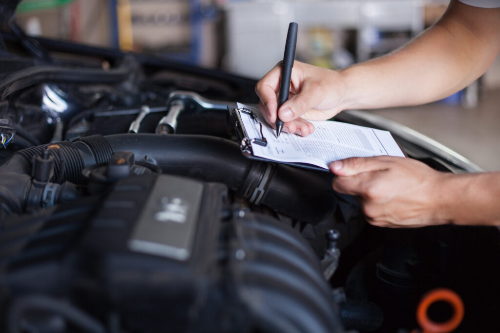 A mechanic inspecting a vehicle. 