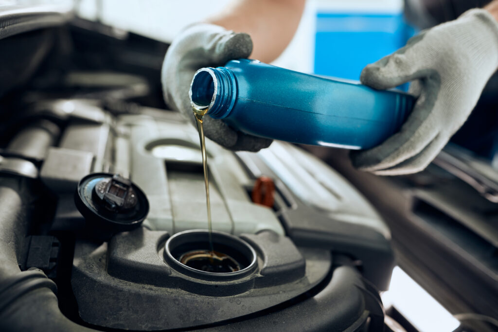 A technician conducting an oil change. 