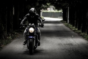 man riding motorcycle with helmet