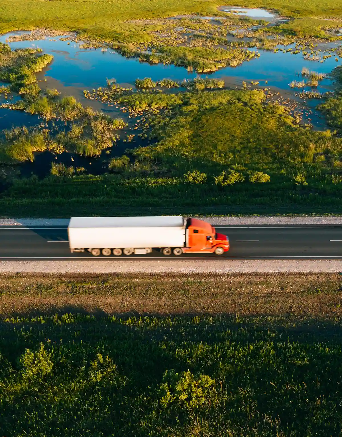 Truck driving along a highway, fleet vehicles rely on AMSOIL for premium synthetic oil