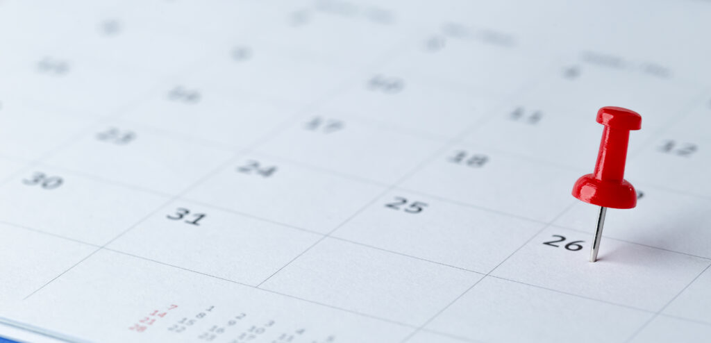 A calendar with push pin.