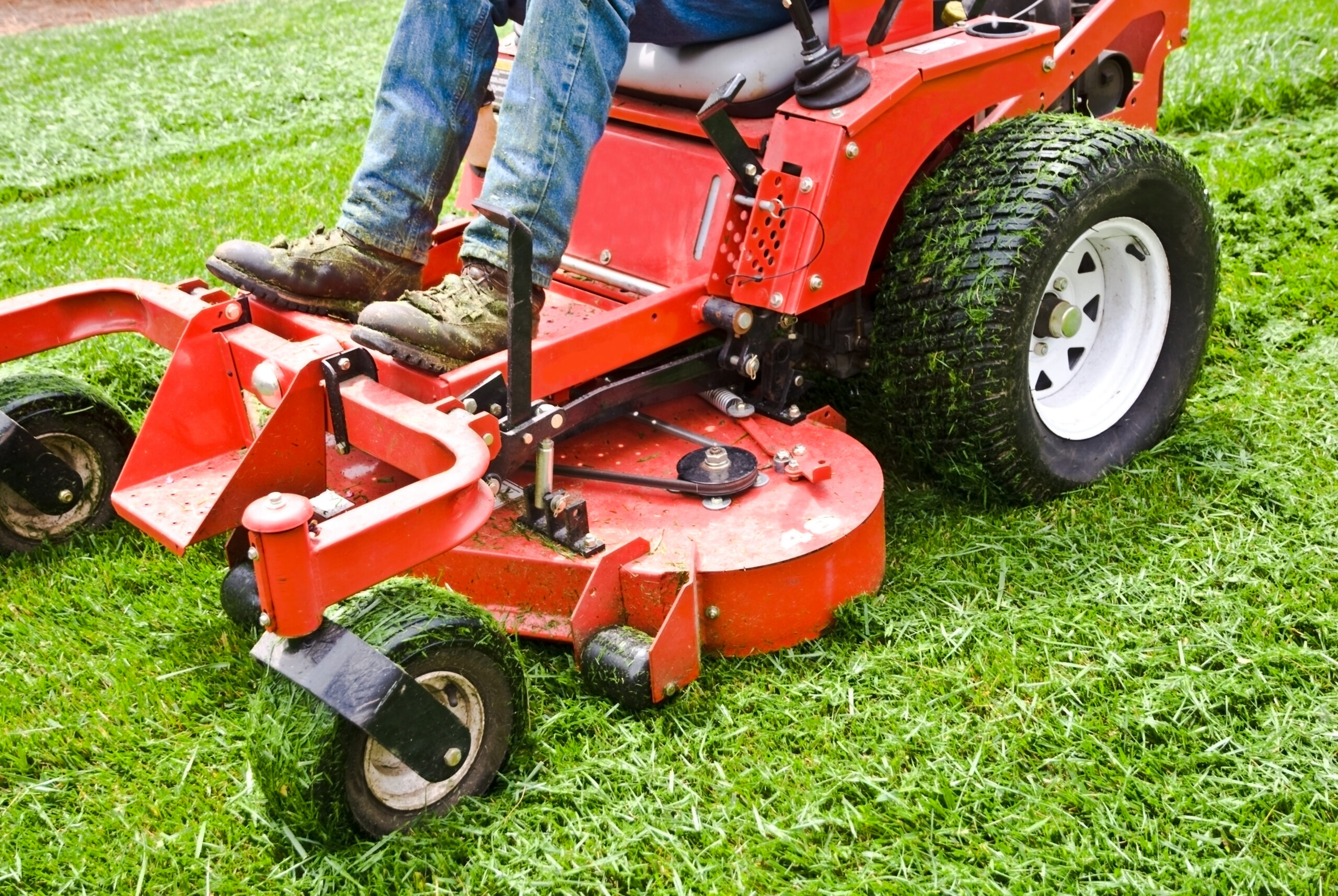 A landscaper on a riding mower.