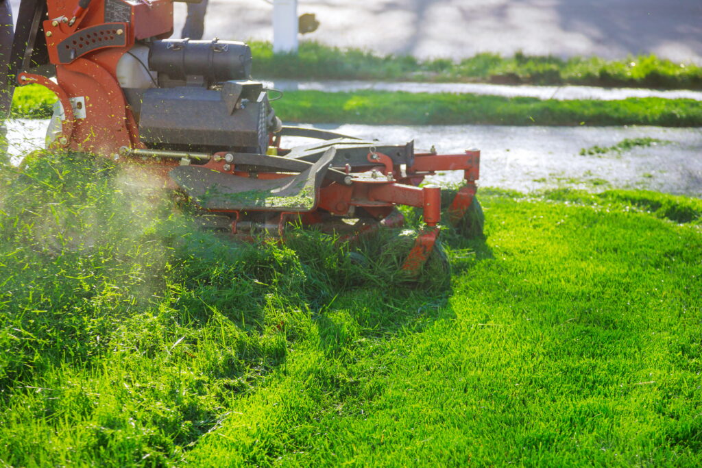a landscaper utilizing a riding lawnmower